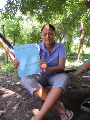 Maira proudly holds up the papers that demonstrate UDP-ABL's legal status.